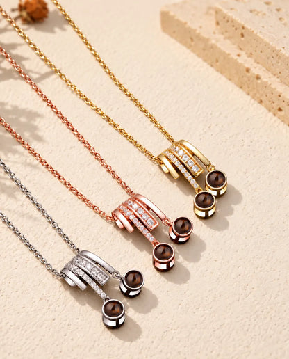 Three colors of the pave slide projection necklace arranged on cream plaster