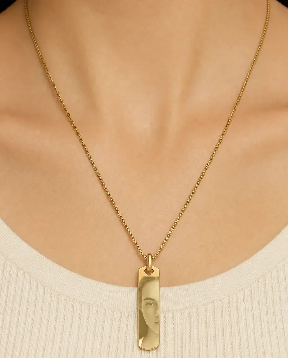 Woman wearing the gold photo engraved bar necklace on a 60 cm box chain
