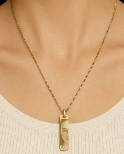 Woman wearing the gold photo engraved bar necklace on a 60 cm box chain