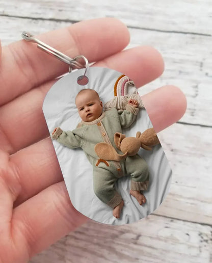 Hand holding the personalized baby photo keychain