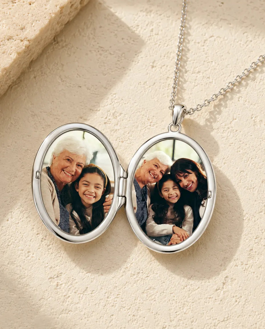 Oval photo locket necklace opened to show the two photos inside