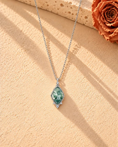 Rose Cut Moss Agate Lozenge Necklace in 925 Sterling Silver - the whole necklace laid out in a long V on a cream textured surface