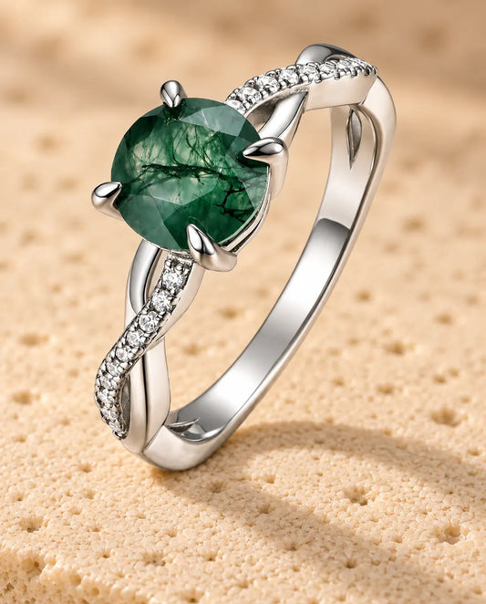 Round Moss Agate Engagement Ring in 925 Sterling Silver - standing upright on a cream textured surface