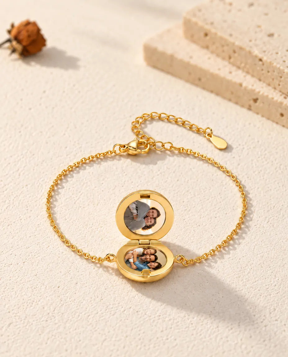 Open round locket bracelet with two photos, seen from a low angle