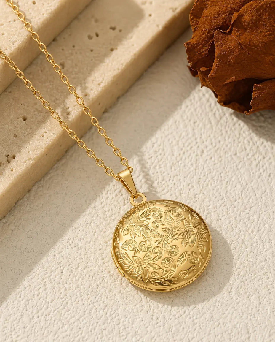 Gold round photo locket necklace with engraved floral scroll front