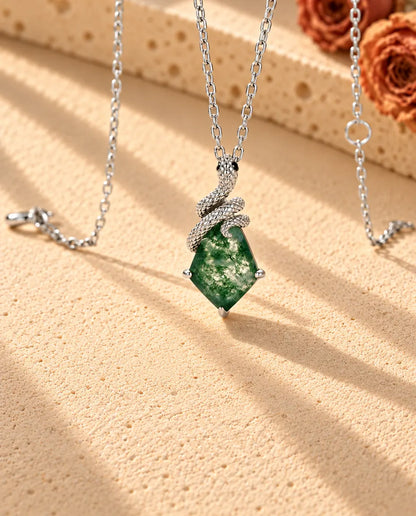 Snake Moss Agate Necklace in 925 Sterling Silver - seen at an angle on a cream textured surface