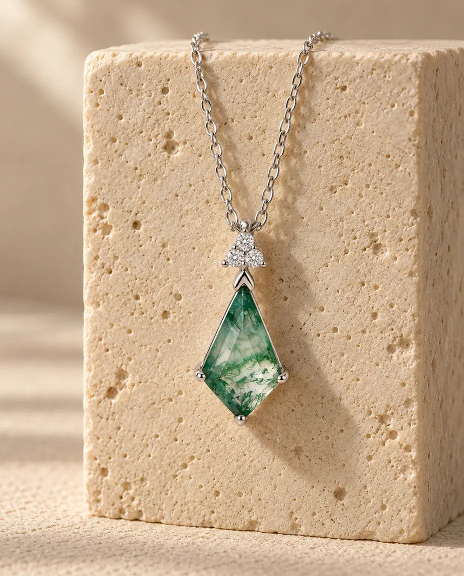 Moss Agate Necklace - displayed on a travertine block