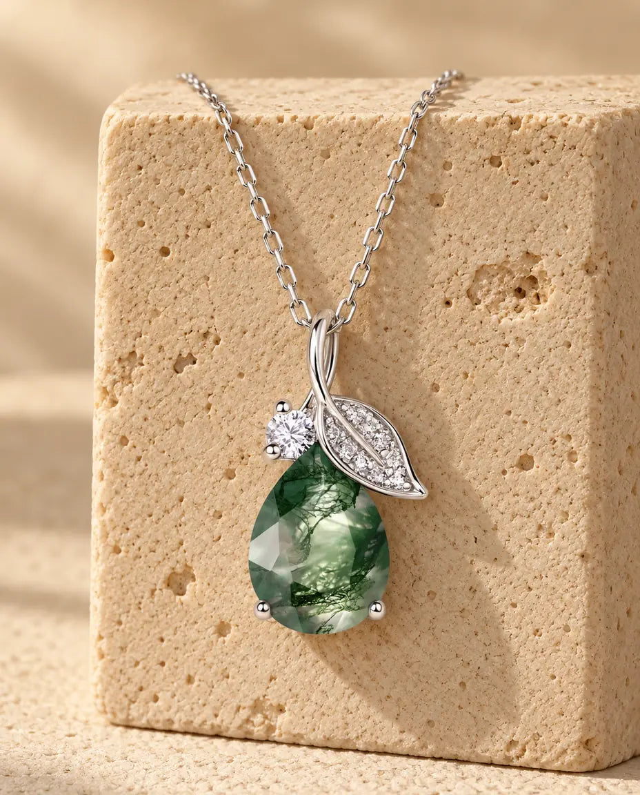 Moss Agate Necklace - displayed on a travertine block