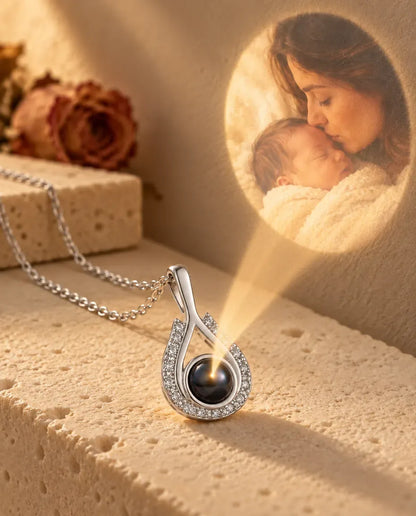 Personalized Teardrop Photo Projection Necklace in Silver - projecting the hidden photo onto a wall