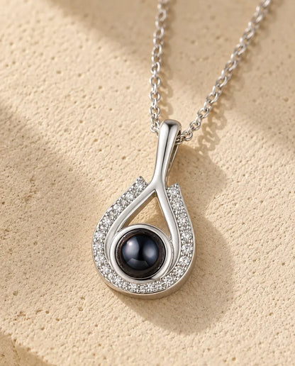 Personalized Teardrop Photo Projection Necklace in Silver - close-up of the projection charm