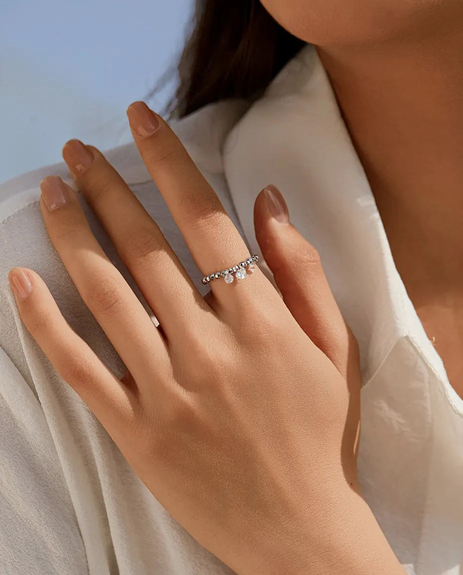Dangle moissanite ring with three swinging stones on adjustable beaded silver band