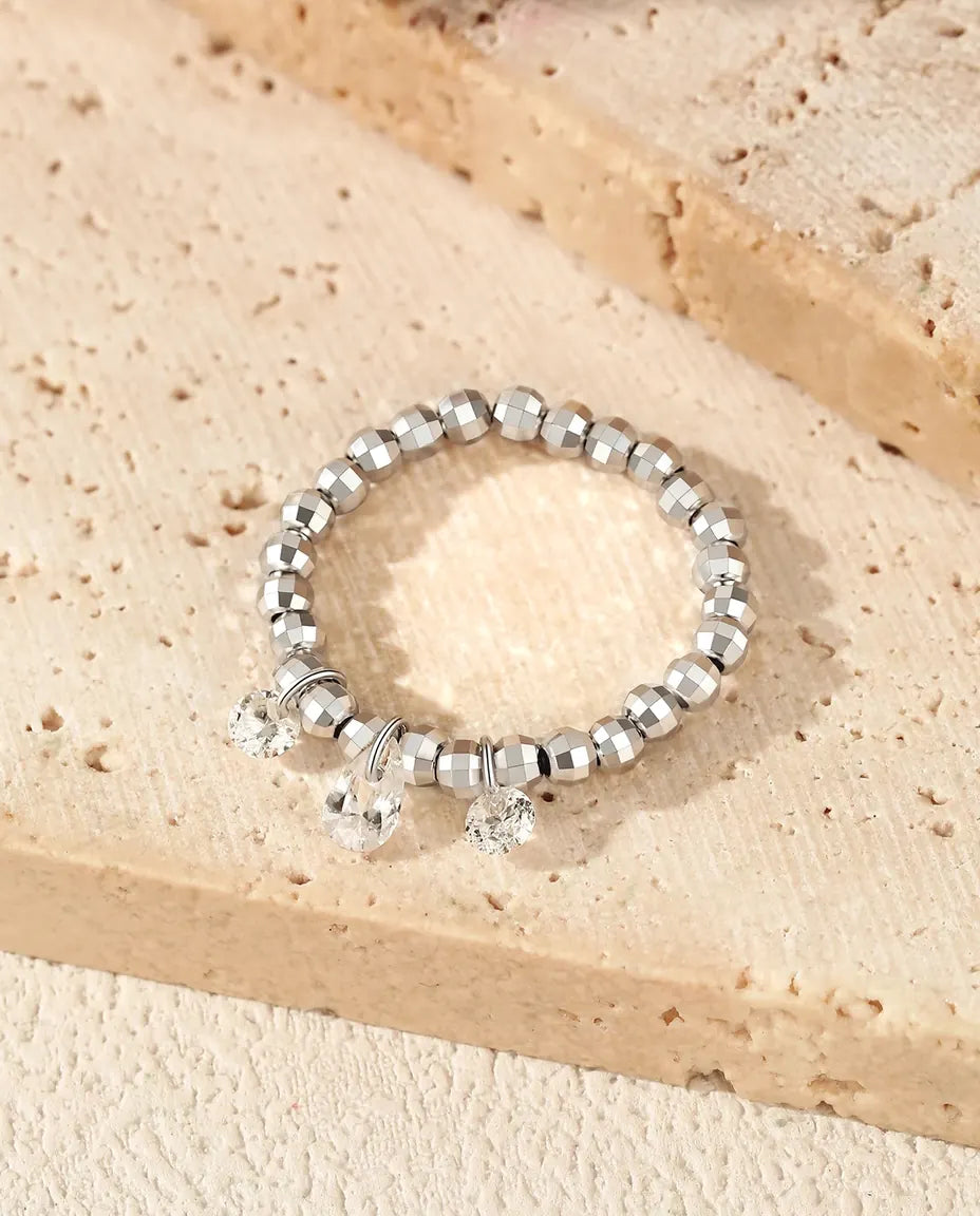 Dangle moissanite ring with three swinging stones on adjustable beaded silver band