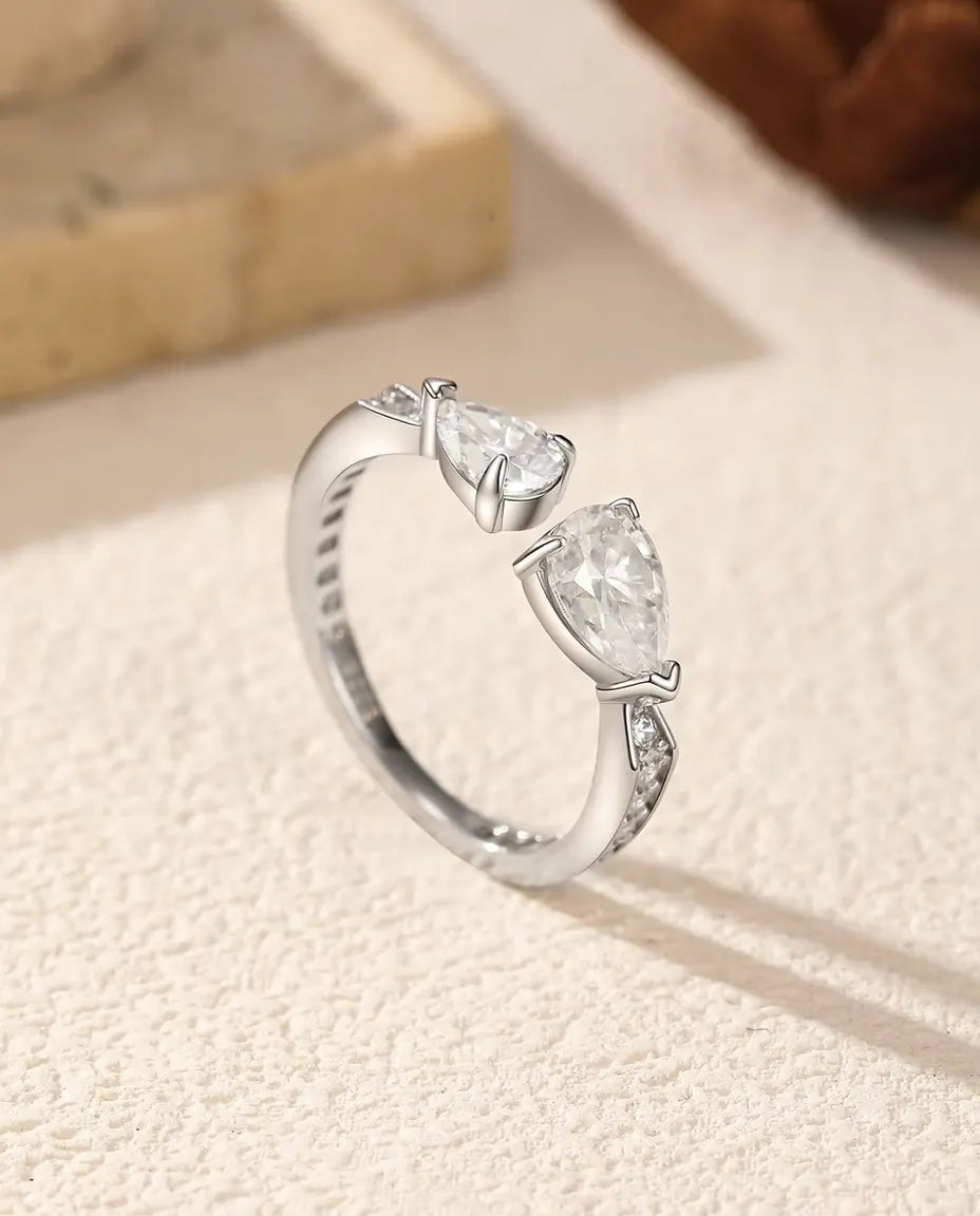Toi et Moi Moissanite Ring in 925 Sterling Silver - standing upright on a cream textured surface