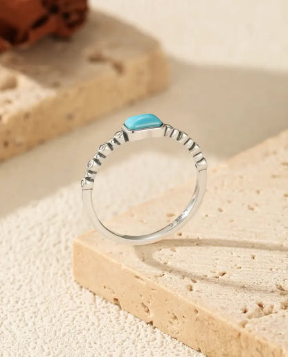 Turquoise cabochon ring on beaded bezel band in 925 sterling silver