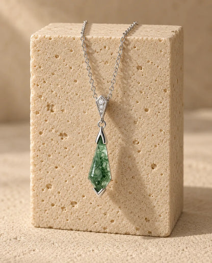 Moss Agate Necklace - displayed on a travertine block