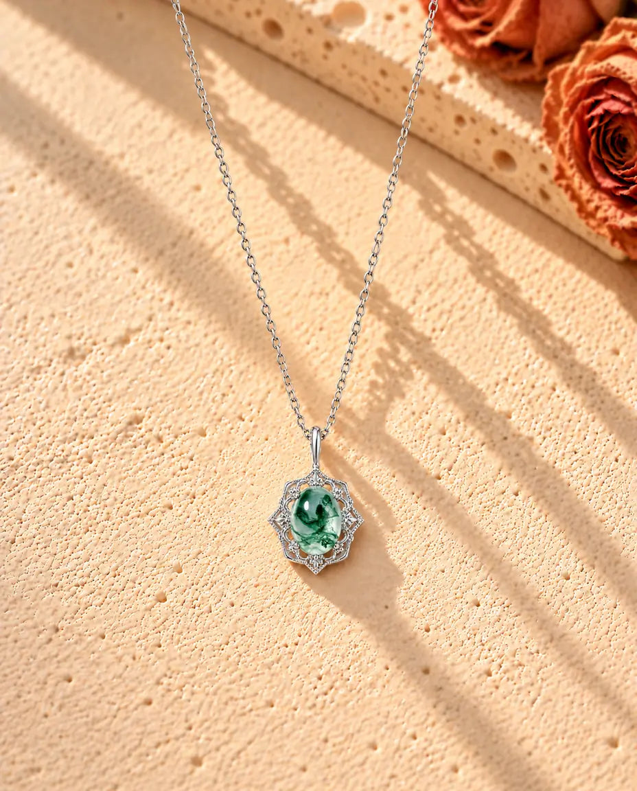 Vintage Moss Agate Pendant Necklace in 925 Sterling Silver - the whole necklace laid out in a long V on a cream textured surface