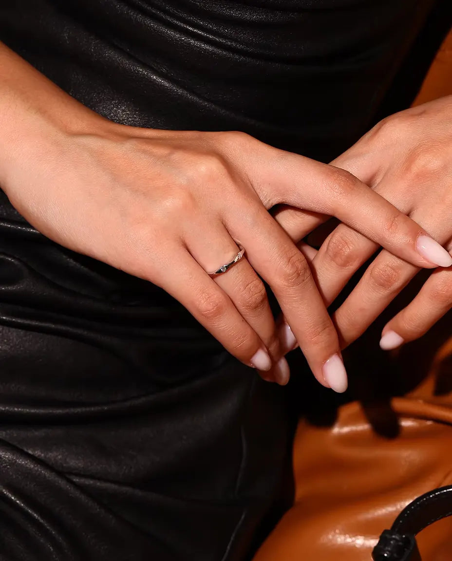 Wavy Moissanite Band Ring in 925 Sterling Silver - worn on a model with hands crossed