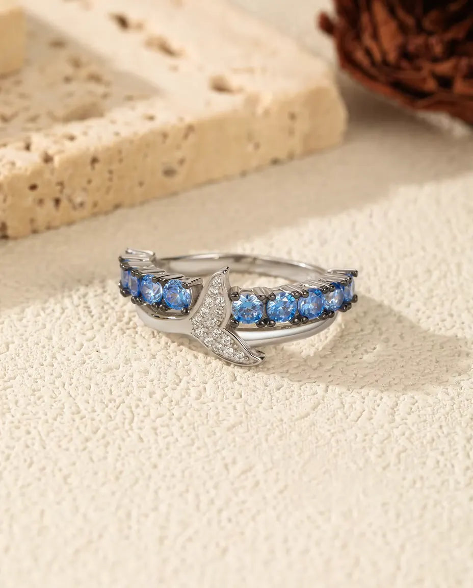 Whale tail ring with blue and white zirconia in 925 sterling silver