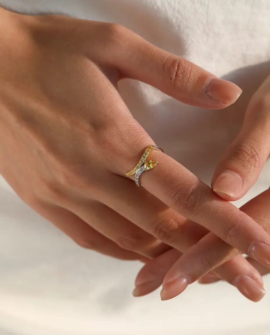 Yellow pear cut bypass ring in 925 sterling silver with two tone pave bands